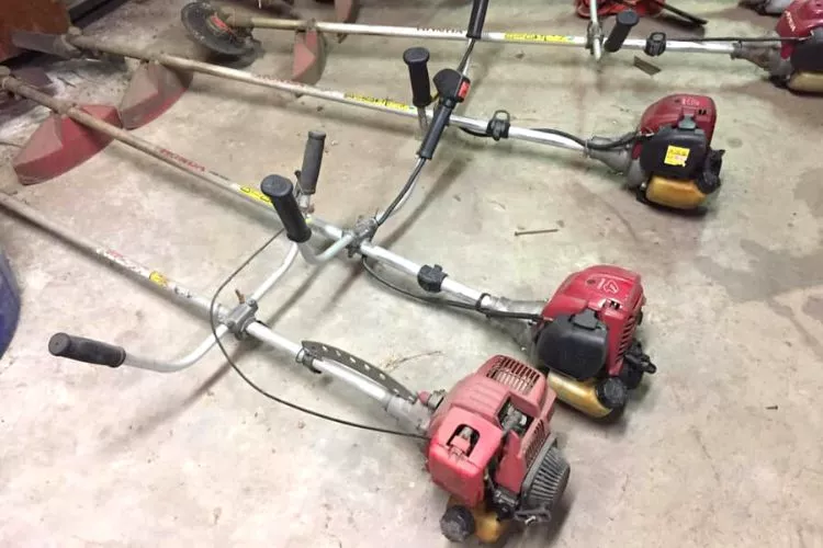 Laying weed eater flat on the floor of the garage 